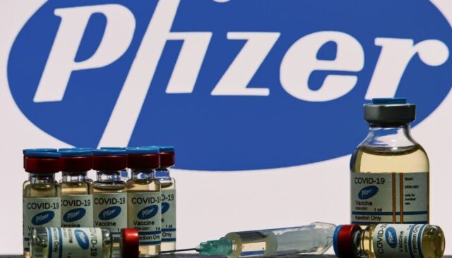 MALLORCA/ESPAÑA- November 13 2020: Pfizer Biontech research Coronavirus (Covid 19) vaccine. Row of vaccine bottles with blurred Pfizer company logo on background.